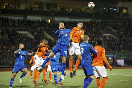 Iceland’s Kari Arnason clears his lines despite pressure from Robin van Persie during Iceland’s 2-0 win over the Netherlands in October.