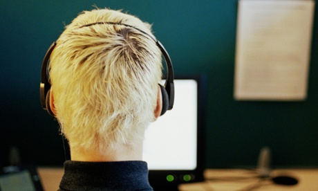 Man in a call centre, wearing headset