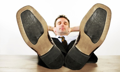 man with feet on desk