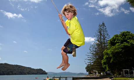 Young boy on rope swing