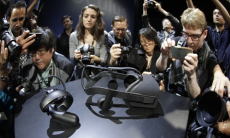 Photographers take pictures of the new Oculus Rift virtual reality headset and touch input device following a news conference Thursday, June 11, 2015, in San Francisco. 