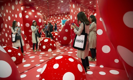 A woman views an exhibition in the Garage Museum.