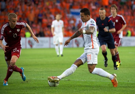 Netherland's Memphis Depay vies for the ball with Latvia's Gints Freimanis. It is goalless in Riga.