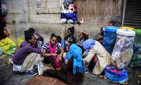 Migrants from Eritrea wait for food at Milan train station on 11 June while the Italian authorities arrange accommodation.