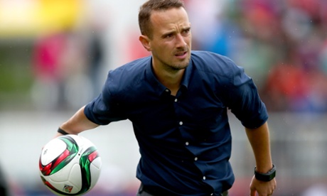 The England coach Mark Sampson returns the ball during England's narrow defeat by France in their opening game.