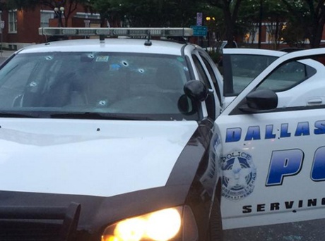 Several bullet holes are seen in the windshield of a police patrol car in Dallas, Texas