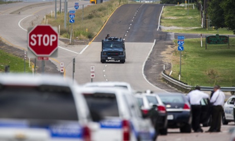 A SWAT vehicle makes its way toward a police staging area at the intersection of Interstate 45 and E Palestine Street.
