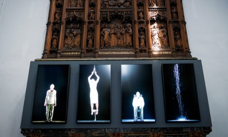 Bill Viola’s video installation is shown front of a the carved 19th-century oak reredos in Auckland Caste, County Durham.