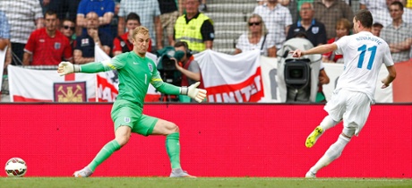 Slovenia's Milivoje Novakovic scores the first goal of the match.
