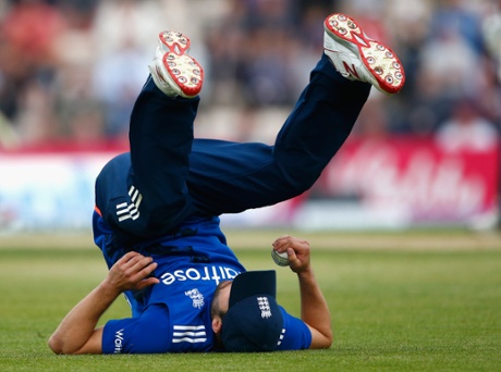 England's Mark Wood of England rolls over in celebration after catching out Kane Williamson.