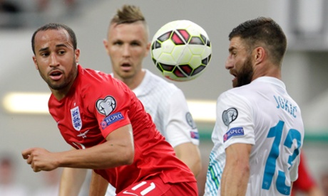Andros Townsend and Slovenia’s Bojan Jokic eye the ball.