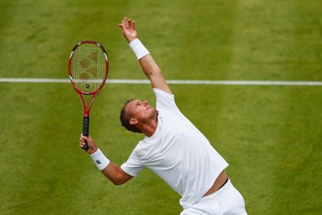 Lleyton Hewitt serves.