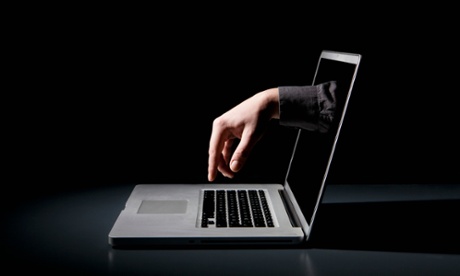 Hand reaching from computer