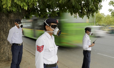 Police officers wear masks as they control traffic in Delhi.