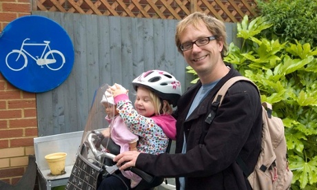 Husband, daughter and doll on bike