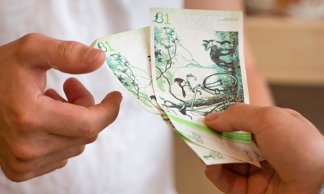 A customer pays for his bread with the Bristol pound at the East Bristol Bakery, which was one of the first businesses to accept the local currency.