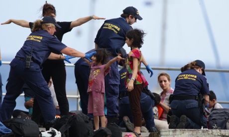 Asylum seekers arrive at Christmas Island in the Indian Ocean in July 2013, after being intercepted by Australian Customs and Border Protection Service officers.