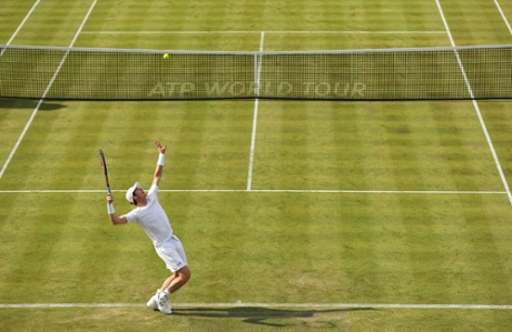Andy Murray serves.