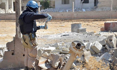 A UN weapons inspector appears to collect samples in Syria, 2013.