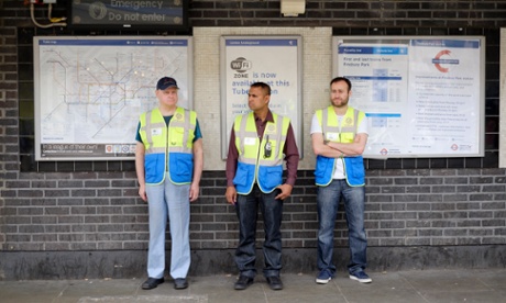 Business and Community Wardens Roger Smith (left), Yilmaz Dursan (right) and supervisor Mohammed Haque (centre) stand around in Finsbury Park, London on Friday, June 12, 2015.  The government's community work placement is intended to give long time unemployed people work experience. However, they say they are standing around for 30 hours a week and get no experience, cannot pay for food and receive no help with applying for jobs.Photograph:    Frantzesco Kangaris