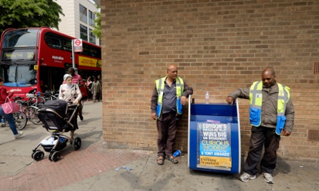Business and Community Wardens Kalil Uddin (left) and Simon Allen (right) stand around in Finsbury Park, London on Friday, June 12, 2015.  The government's community work placement is intended to give long time unemployed people work experience. However, they say they are standing around for 30 hours a week and get no experience, cannot pay for food and receive no help with applying for jobs.Photograph:    Frantzesco Kangaris