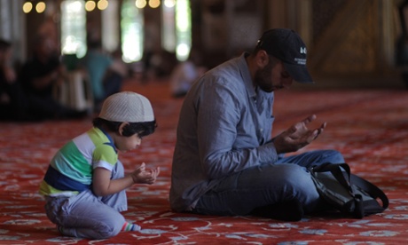 Ramadan in Istanbul: A Turkish man and his son praying at the Blue Mosque in Istanbul on the first day of the fasting month of Ramadan in Turkey last year