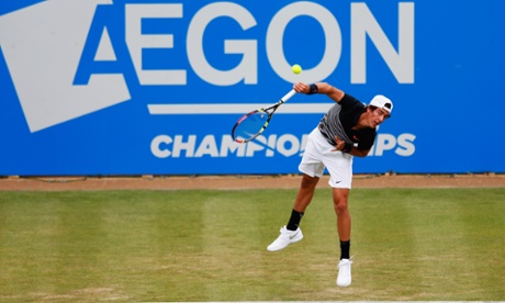 Thanasi Kokkinakis serves against Gilles Simon.