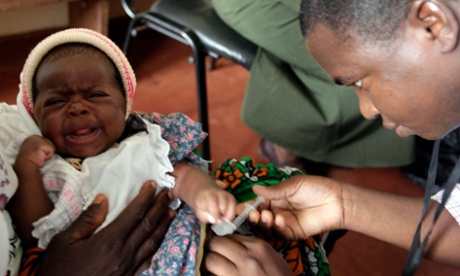 A child is given an injection as part of a malaria vaccine trial 