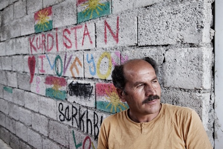 Syrian refugee Ahmad Khalif supports other refugees who arrive at Darashakran refugee camp, Iraq