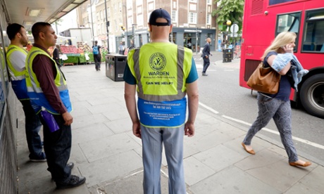 Business and Community Wardens Roger Smith (right), Yilmaz Dursan (left) and supervisor Mohammed Haque (centre) stand around in Finsbury Park, London on Friday, June 12, 2015.  The government's community work placement is intended to give long time unemployed people work experience. However, they say they are standing around for 30 hours a week and get no experience, cannot pay for food and receive no help with applying for jobs.Photograph:    Frantzesco Kangaris