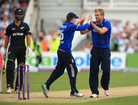 David Willey is congratulated by England captain Eoin Morgan after taking the wicket of  New Zealand's Kane Williamson.