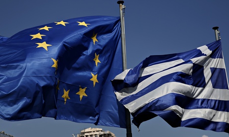An EU and a Greek flag fly in front of the Parthenon