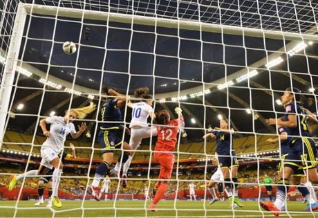 Sandra Sepulveda of Colombia punches the ball away despite the close attention of Karen Carney.