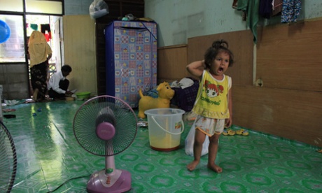 A Rohingya girl stands in her house on the outskirts of Bangkok, Thailand.
