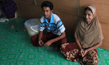 Rohingya woman Azima sits next to her husband, Hussein, at his family apartment in Bangkok, Thailand.