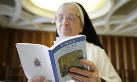 A nun reads Pope Francis's encyclical at the Vatican