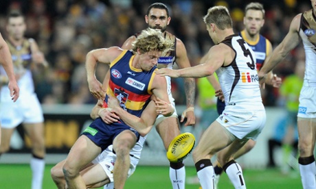 Rory Sloane is tackled by Matt Suckling at Adelaide Oval