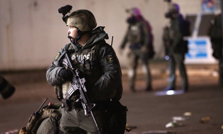 A police officer patrols in Ferguson, Missouri, during protests over the shooting death of Michael Brown.