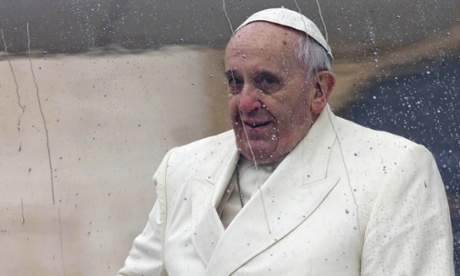 In this Wednesday, Jan. 22, 2014 file photo Pope Francis sits in his rain-covered pope-mobile as he leaves after his weekly general audience in St. Peter's Square at the Vatican. Pope Francis released his much-anticipated encyclical 'Laudato Si' (Praise Be), on the environment Thursday, declaring an urgent need for the political and spiritual conversion of global leaders and individuals to dedicate themselves to curbing climate change and ending policies and personal habits that destroy creation.