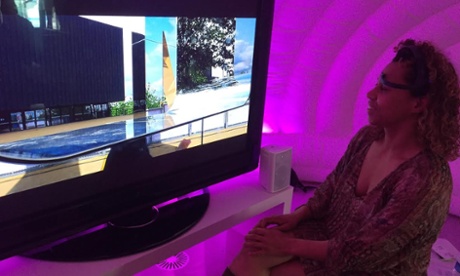 Karen Palmer wearing the EEG headset in her cosy neurogaming igloo.