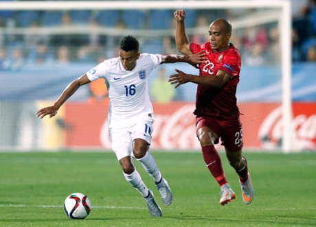 Jesse Lingard takes on Portugal's Joao Mario.