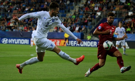 Carl Jenkinson crosses the ball past Portugal's Sergio Oliveira.