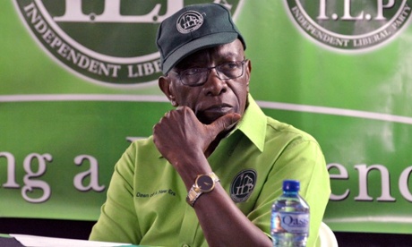 Jack Warner listens to the speaker during a cottage meeting of his political organisation, the Independent Liberal Party, in the village of Surrey, Lopinot, Arouca, in Trinidad.