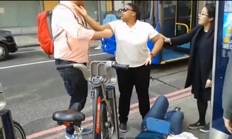 Passers-by remonstrate with the driver of the tour bus.