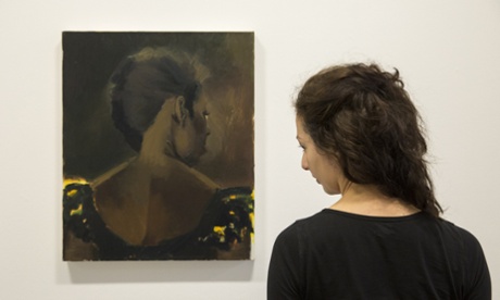 A member of the gallery staff poses beside Lynette Yiadom-Boakye's 2015 painting 'The Matches' at the Serpentine Gallery.