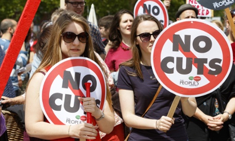 Protesters in Bristol carry anti-austerity placards .