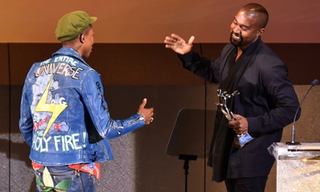 Kanye West presents the Fashion Icon Award to Pharrell Williams.