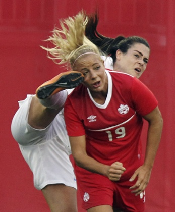 England's Claire Rafferty, pictured with her foot dangerously close to Adrianna Leon's face in the warm-up against Canada, had a career-saving operation financed by her parents nine years ago.