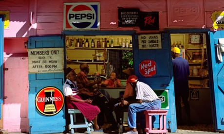 Rum Shack Bar in West Indies, Guinness and pepsi logos are shown and four men are sat chatting