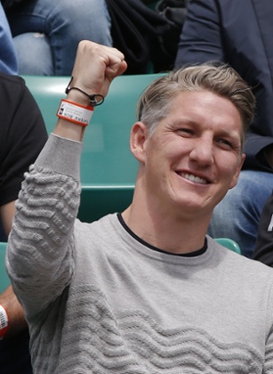 Bayern & Germany football player Bastian Schweinsteiger clenches his fist as Serbia’s Ana Ivanovic wins a point.